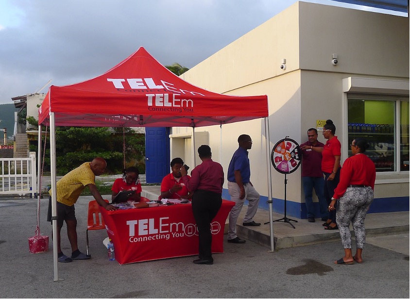 TelEm Fiber sales and marketing representatives, Selena Levy and Josiah Pantophlet, on the forecourt of the Sol Antilles Yuppie Station, Sucker Garden Road, Wednesday, for the telEm Fiber/Sol Antilles Fuel the Season campaign.